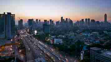 Photo high angle view of street amidst buildings against sky during sunset