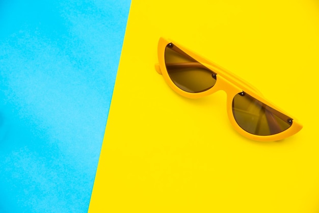 high angle view of sunglasses on colored background