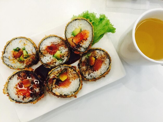 High angle view of sushi and herbal tea on table