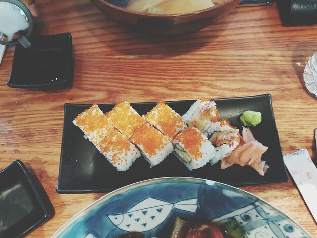 Photo high angle view of sushi served on table