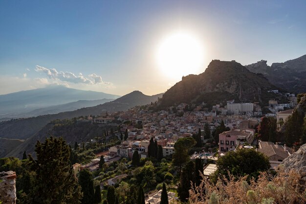 High angle view of taormina townscape against sky and etna vulcan