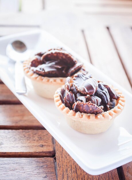 High angle view of tart in plate with spoon on table