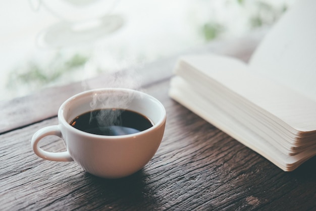 high angle view of tea cup with book on table