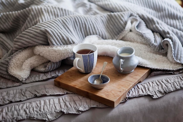 High angle view of tea with milk served on bed at home