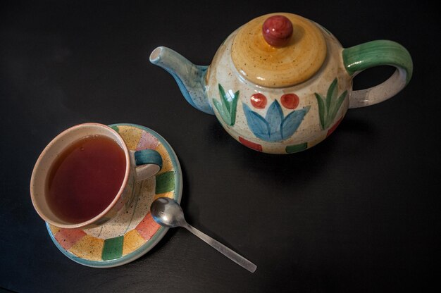 High angle view of teapot and cup on table