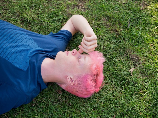 High angle view of teenage boy lying on grassy land