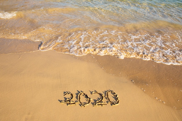Photo high angle view of text on sand at beach