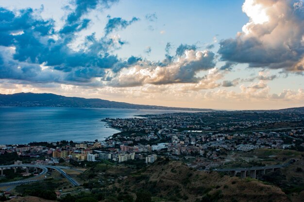 High angle view of town by sea against sky