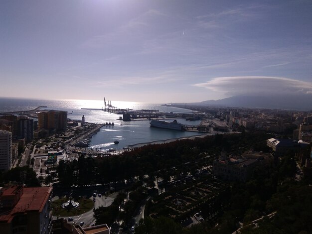 High angle view of town by sea against sky