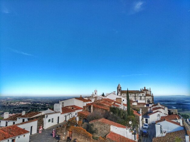 High angle view of townscape against blue sky