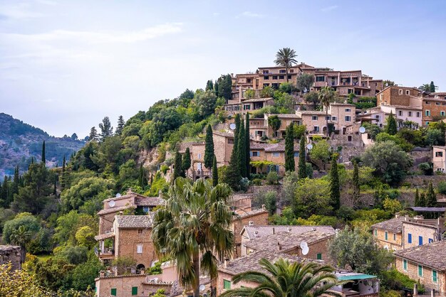 High angle view of townscape amidst trees on mountains against blue sky