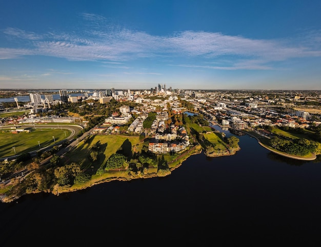 High angle view of townscape by lake against sky in city