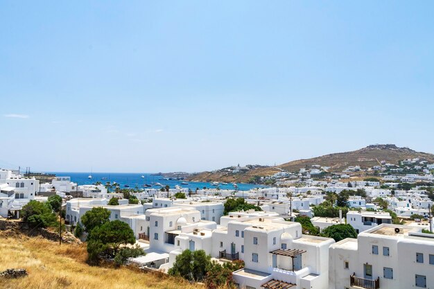 High angle view of townscape by sea against clear sky