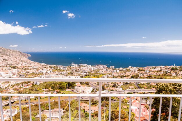 High angle view of townscape by sea against sky