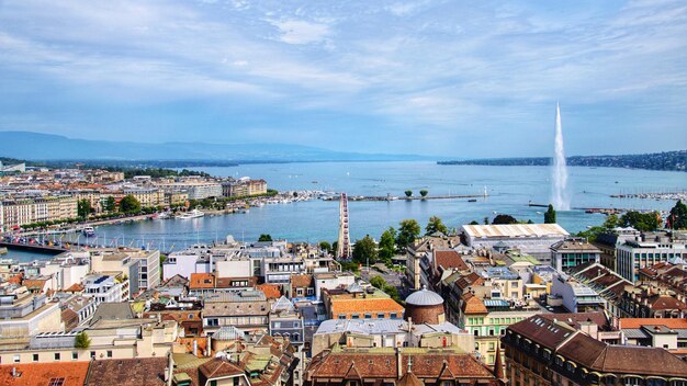 High angle view of townscape by sea against sky