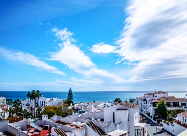 High angle view of townscape by sea against sky