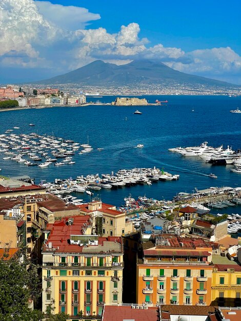 High angle view of townscape by sea against sky