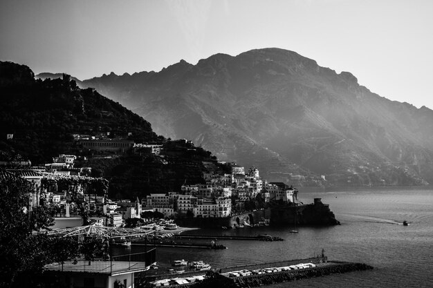 High angle view of townscape by sea against sky