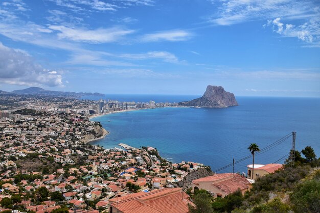 High angle view of townscape by sea against sky