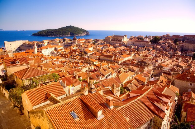 High angle view of townscape by sea against sky