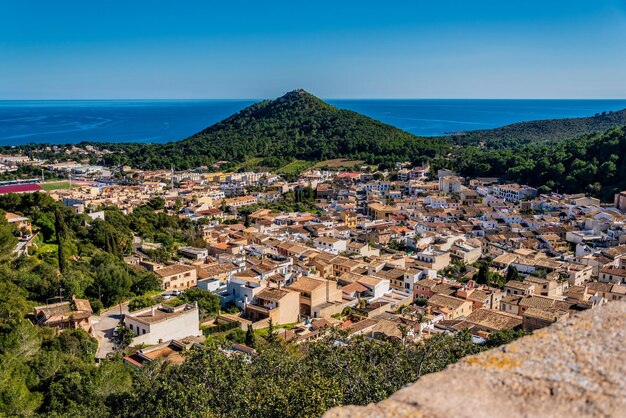 High angle view of townscape by sea against sky