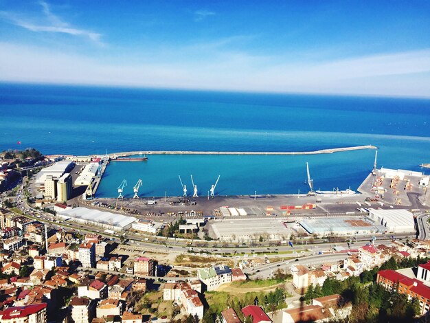 High angle view of townscape by sea against sky