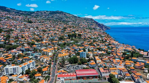 High angle view of townscape by sea against sky