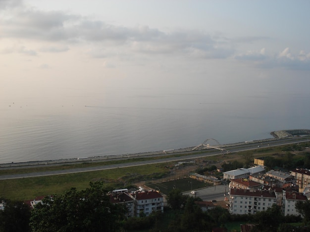 High angle view of townscape by sea against sky