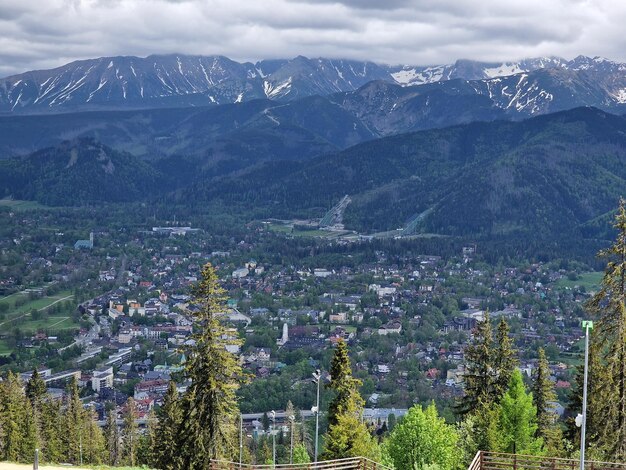 High angle view of townscape and mountains against sky