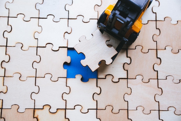 Photo high angle view of toy car on wooden jigsaw pieces