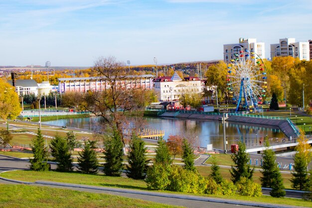 High angle view of trees by river in city against sky