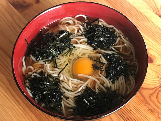 High angle view of udon noodles soup in bowl on table