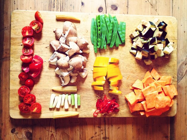 High angle view of various chopped vegetable on cutting board