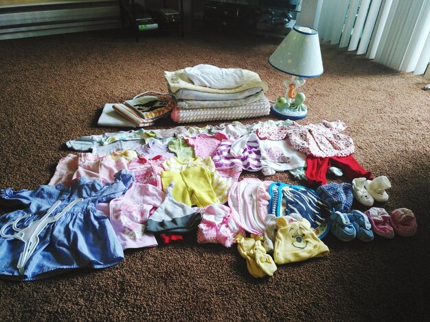 Photo high angle view of various clothes on floor at home