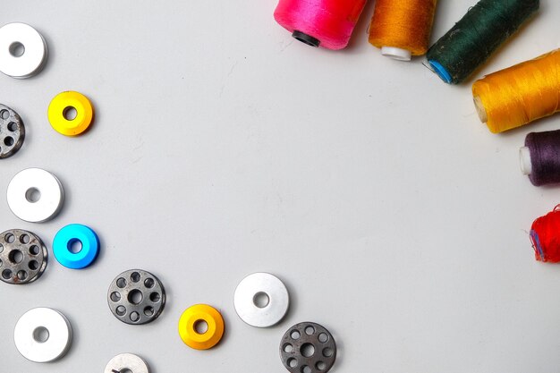 High angle view of various sewing equipment on white table