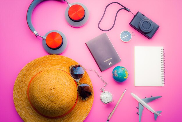 Photo high angle view of various traveling equipment on pink background