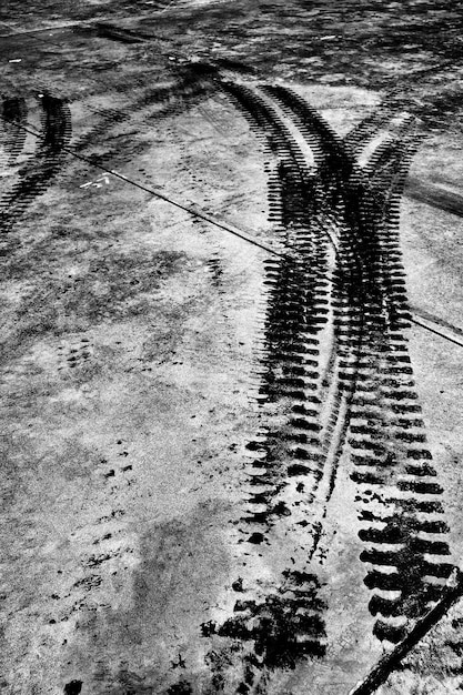 High angle view of wet tire tracks in puddle during winter