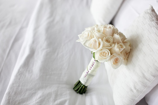 high angle view of white rose on bed