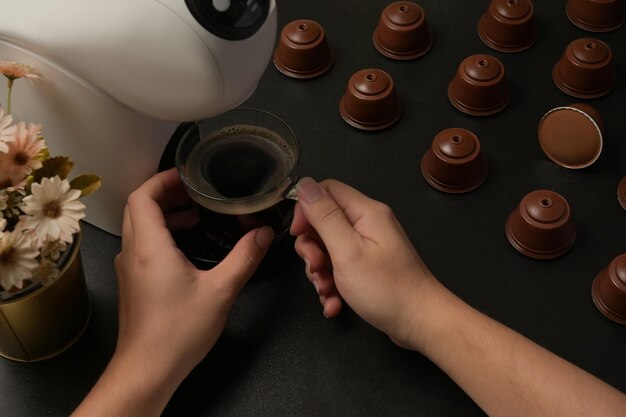 High angle view of woman holding coffee cup on table