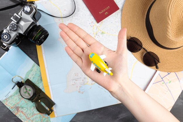 High angle view of woman holding hat on table