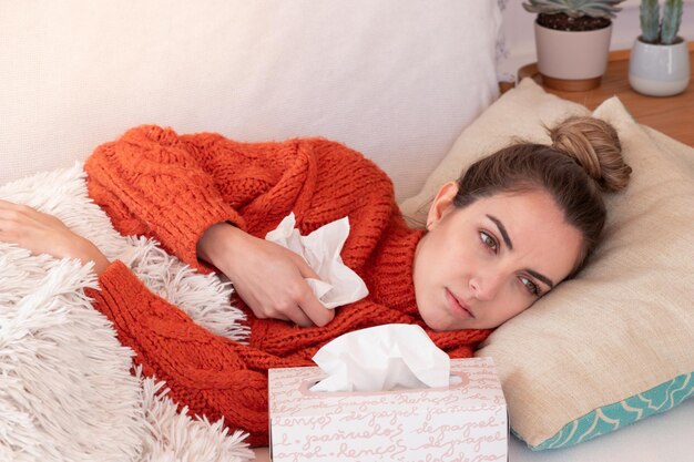 High angle view of woman lying on bed at home