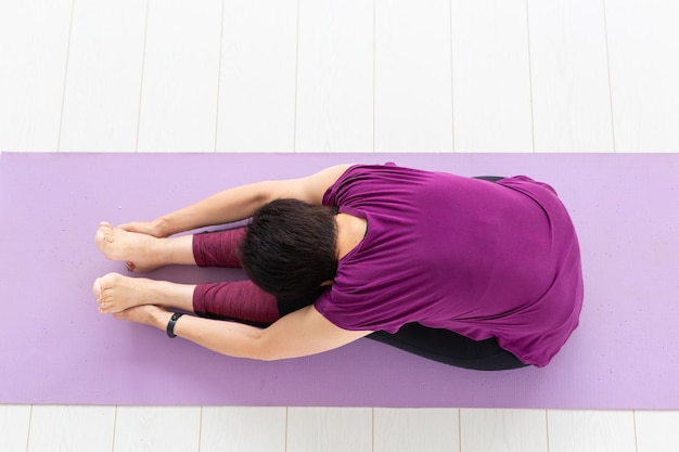 High angle view of woman lying on wall