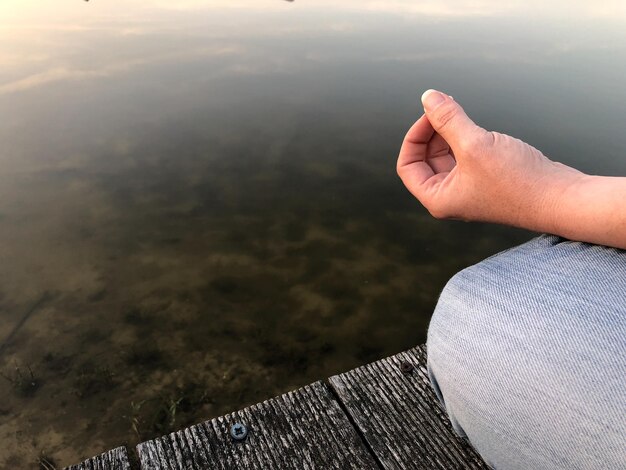 湖の近くで瞑想している女性の高角度の景色