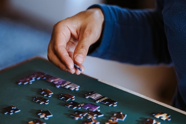 High angle view of woman playing with puzzle