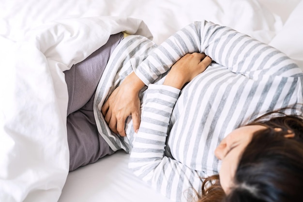 high angle view of woman resting on bed