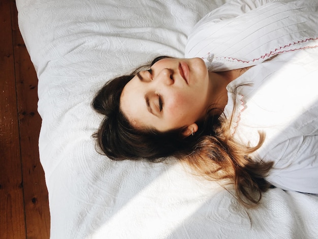 high angle view of woman sleeping on bed at home