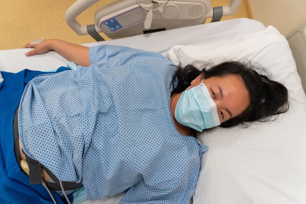 High angle view of woman sleeping on bed