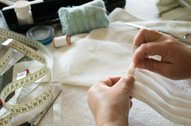 High angle view of woman stitching clothing