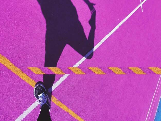 High angle view of woman stretching on playing field