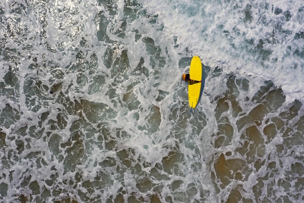 High angle view of woman surfing in sea